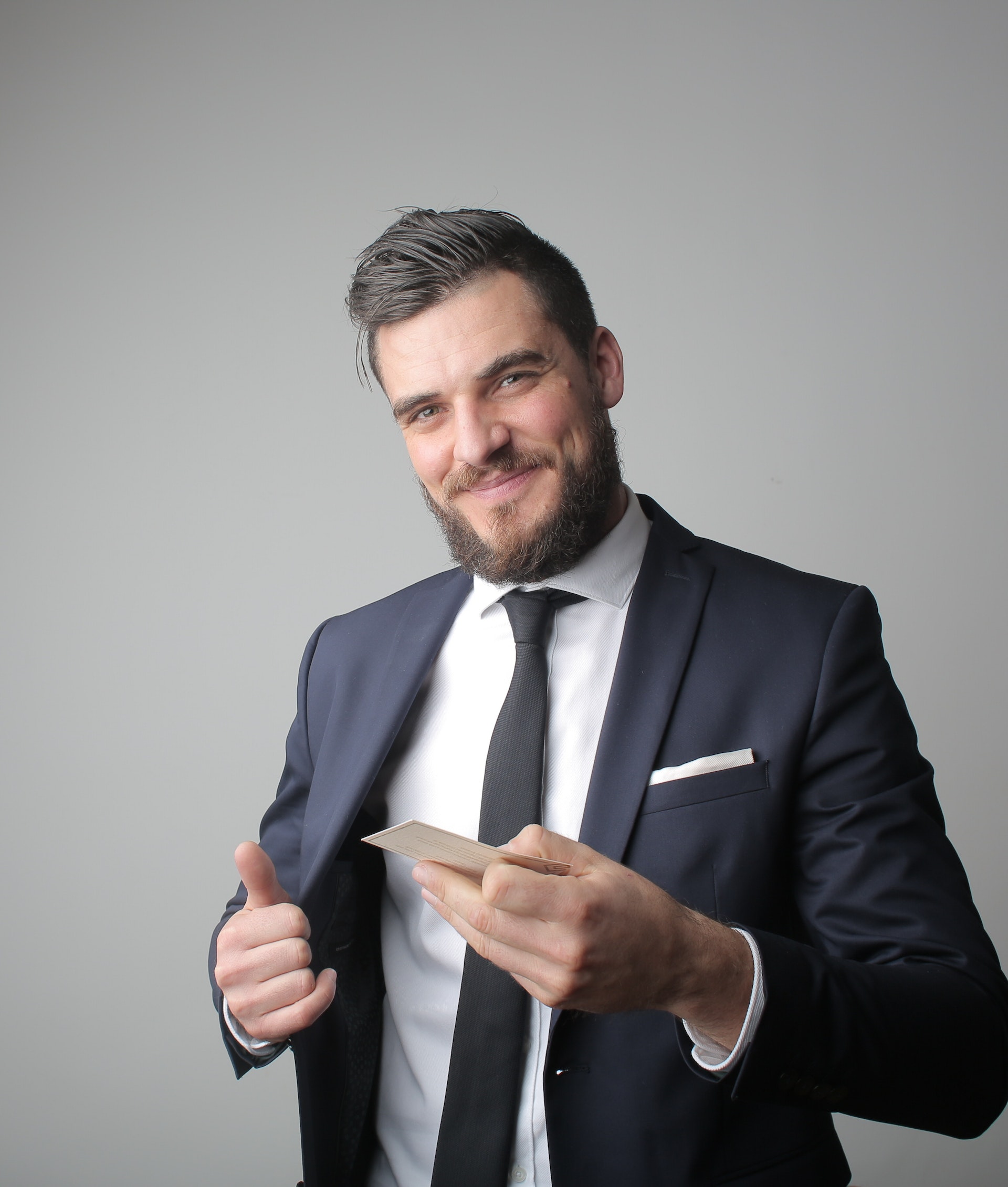 Man in Black Suit Holding a Calling Card